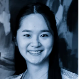 A smiling woman with long hair in a blue-tinted photograph.